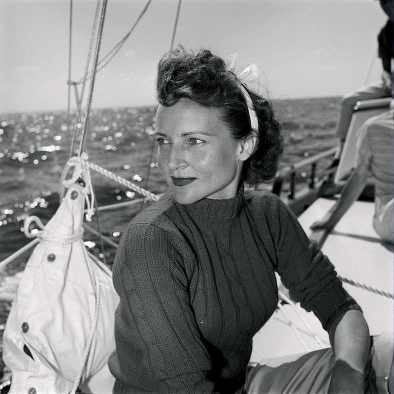 Actress Betty White photographed during a boat trip in 1957, emphasizing the importance of cultivating integrity through hard work.