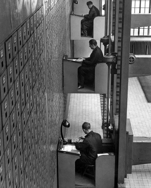 In 1937, File Clerks in Prague Embrace Electric Elevator Desks 🖥️