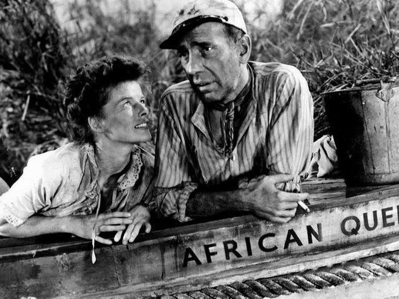 Classic 1951 film 'African Queen' features Katherine Hepburn and Humphrey Bogart in a memorable scene.
