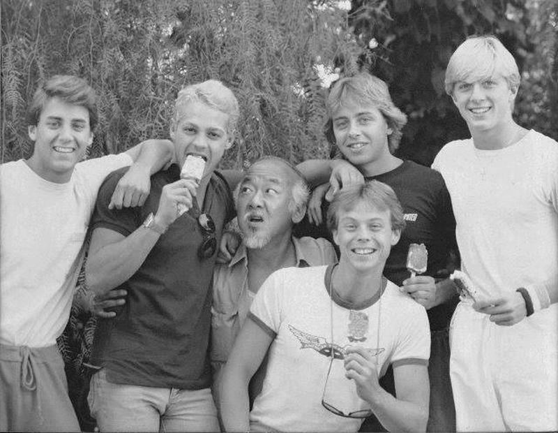 Pat Morita pictured with the Cobra Kai actors on the set of 'Karate Kid' in 1984.
