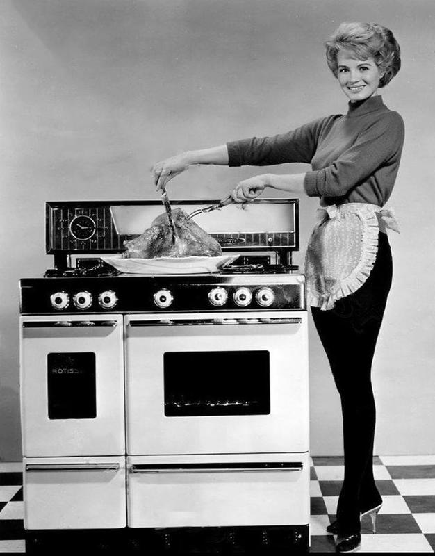 Angie Dickinson showcasing her turkey carving skills in the early 1960s.