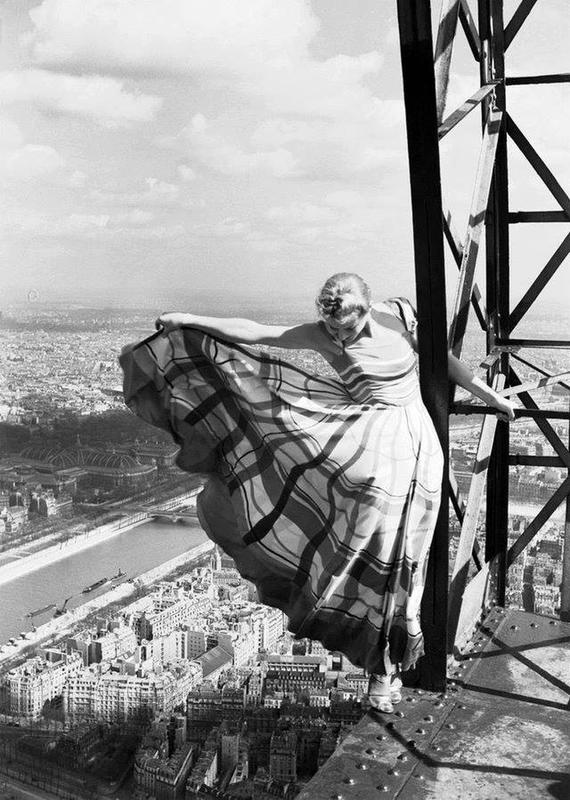 Lisa Fonssagrives poses on the edge of the Eiffel Tower for Vogue Magazine in 1939.