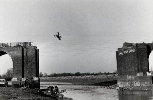 British daredevil Eddie Kidd jumps 80-ft gap on abandoned River Chelmer railway for film 'Riding High' in 1979.
