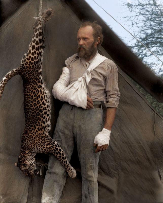 Carl Akeley triumphs over leopard attack, poses with bare-handed victory, 1896