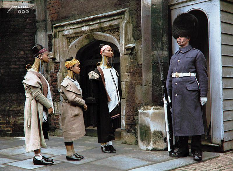 Women with elongated necks, known as Giraffe Women, stand watch at the main entrance of St. James' Palace in London, 1935