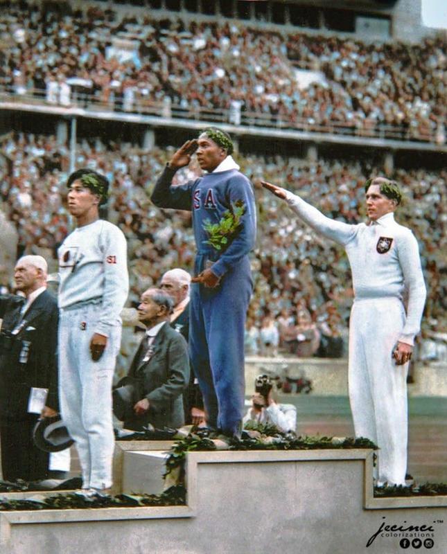 Jesse Owens, American athlete, salutes while receiving gold medal for long jump victory over Nazi Germany's Lutz Long at the 1936 Summer Olympics in Berlin