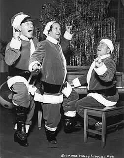 Three Stooges donning Santa attire.