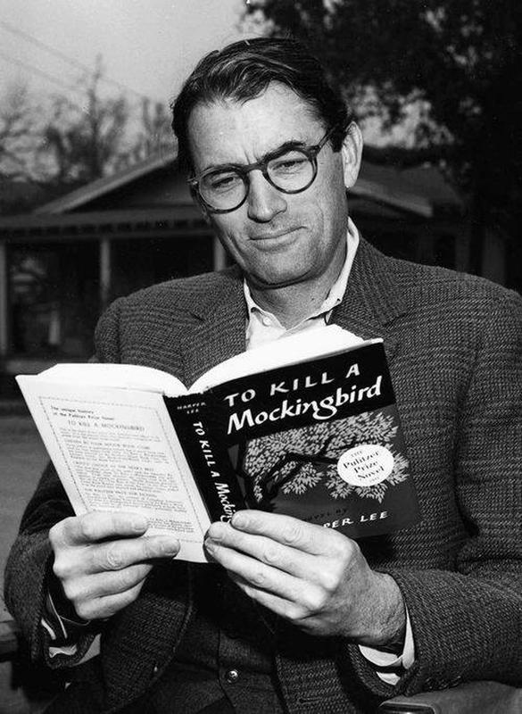 Gregory Peck engrossed in book on 'To Kill a Mockingbird' set, 1962.