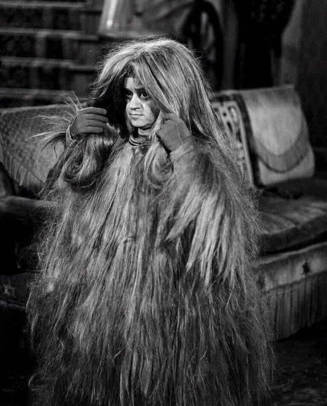 Actor Felix Silla dons 'Cousin Itt' costume on 'The Addams Family' set, 1965