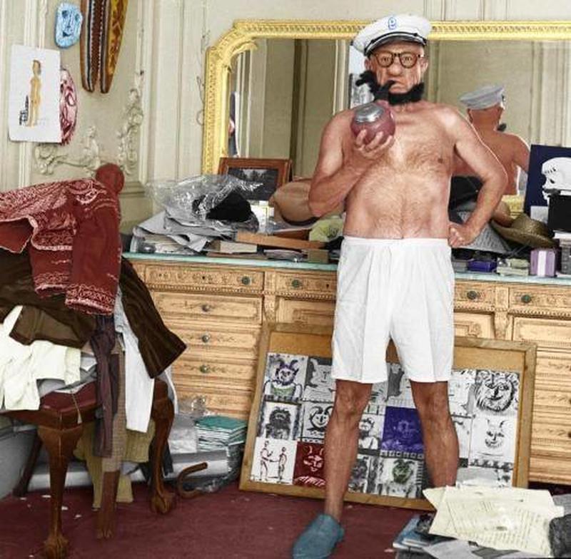 In 1957, Pablo Picasso dons Popeye costume in his messy room.
