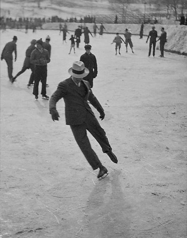1937: Elegant Gentleman Effortlessly Glides on Ice in Formal Wear