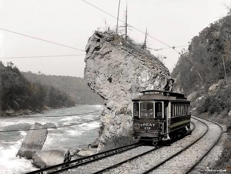 Massive rock, Niagara Gorge Railroad, accents Niagara Falls.