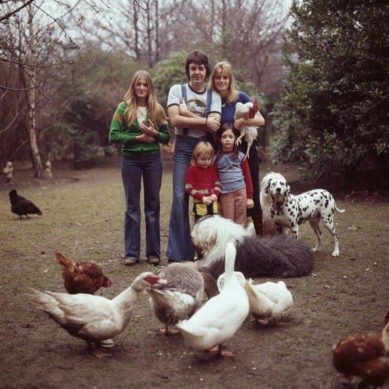 Paul and Linda McCartney enjoy family time with their children and pets in their London home's garden, 1976.