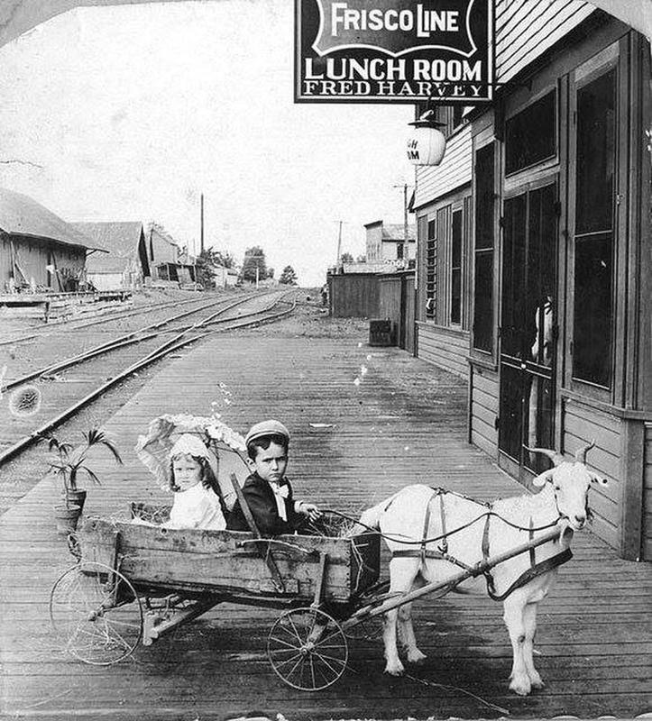 Goat cart-riding Arkansas youngsters flaunt their style while hitting the town in the early 1900s!