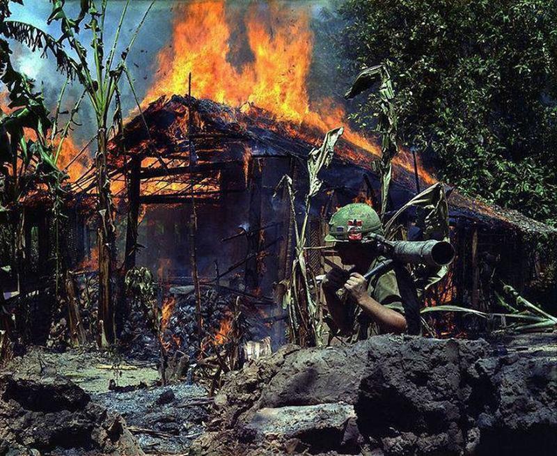 Vietnamese Village Devastated by Fire Navigated by American Soldier