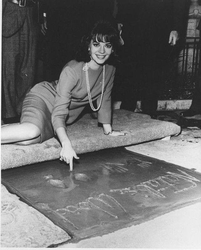 Natalie Wood joyfully caught on camera as she etches her name in cement at Grauman's Chinese Theater in the 1960s.