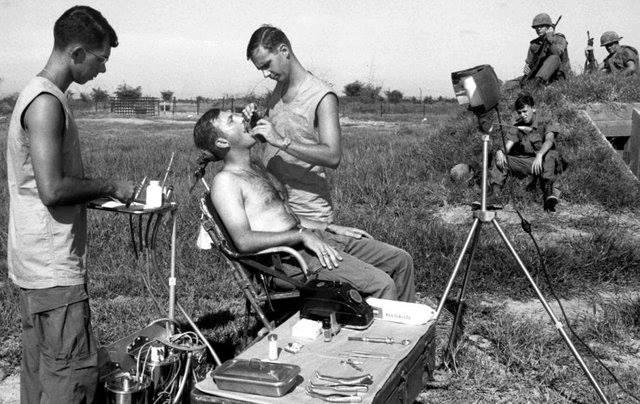 Captain Earle Yeamans, a Dentist, Extends Dental Care to Soldier in Vietnam during the Year 1968