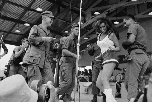 Raquel Welch joyfully joins our troops for a dance during the 1967 USO Christmas Tour.