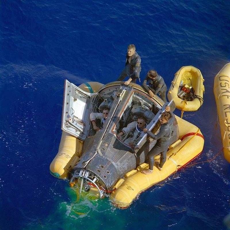 Neil Armstrong and David Scott patiently wait for the recovery ship with their spacecraft hatches open following the Gemini VIII mission in 1966.