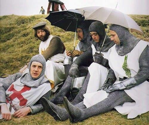 Cast members of the British comedy film 'Monty Python and the Holy Grail' spotted on the rainy set in 1975.