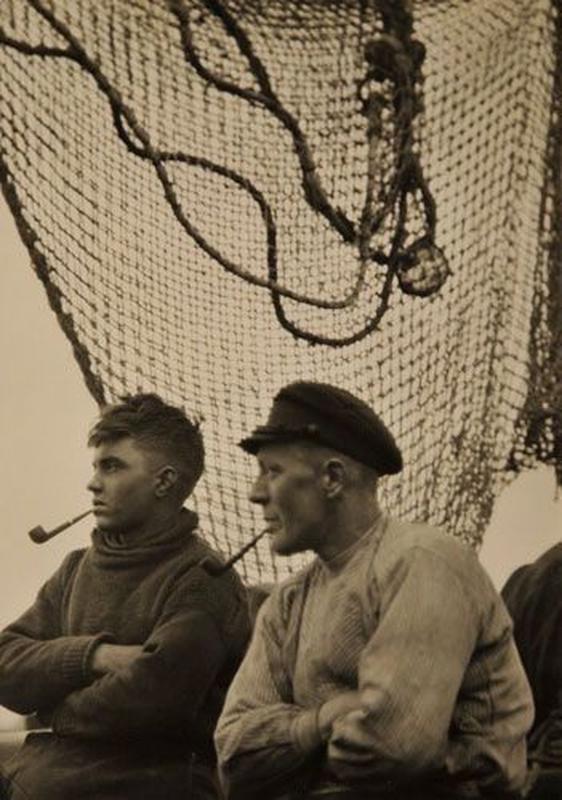 Two strong fishermen eagerly anticipate their departure to the sea