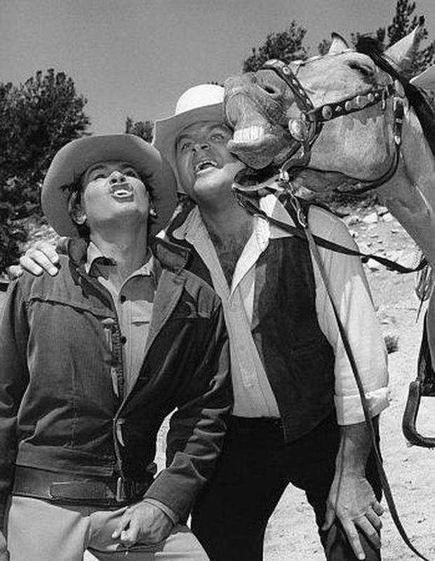 Bonanza TV Series: Little Joe Cartwright and Hoss Attempting to Match Their Horse's Smile on Set