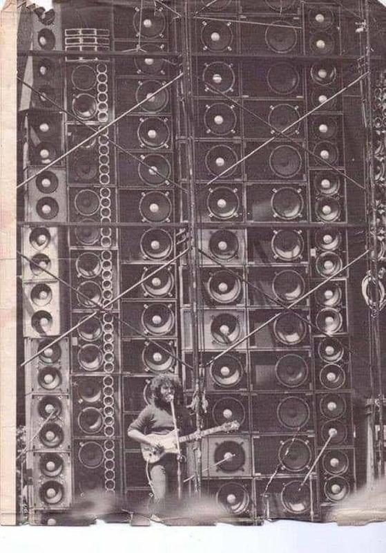 Jerry Garcia poses in front of the Grateful Dead's 'Wall of Sound' during the year 1974.