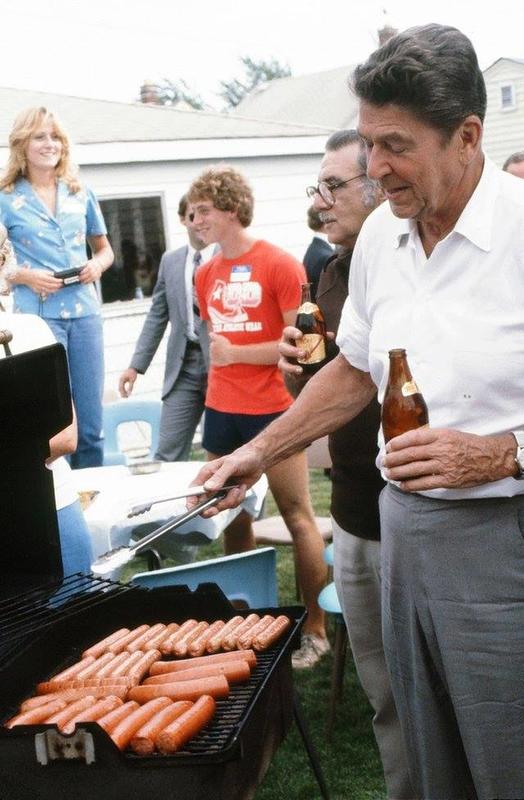 President Ronald Reagan cooking hot dogs on the grill in 1980.