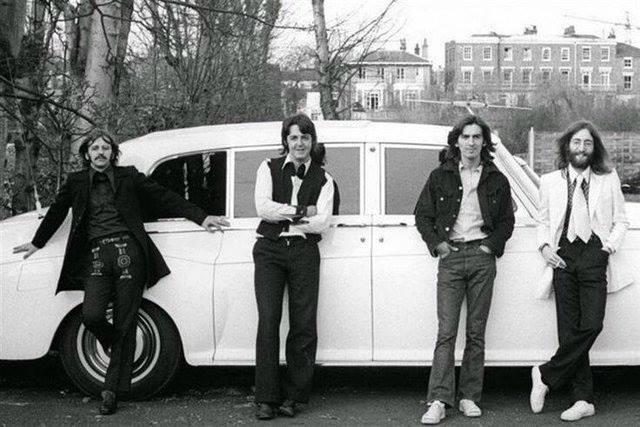 The Beatles pose beside John Lennon's 1965 Rolls-Royce Phantom V in 1969.