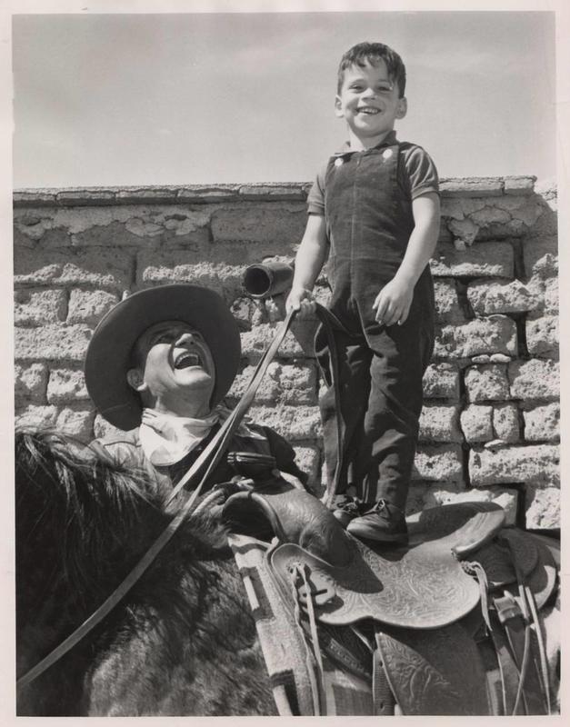 John Wayne and his son Ethan enjoy their time on the set of 'The Sons of Katie Elder' in 1965.