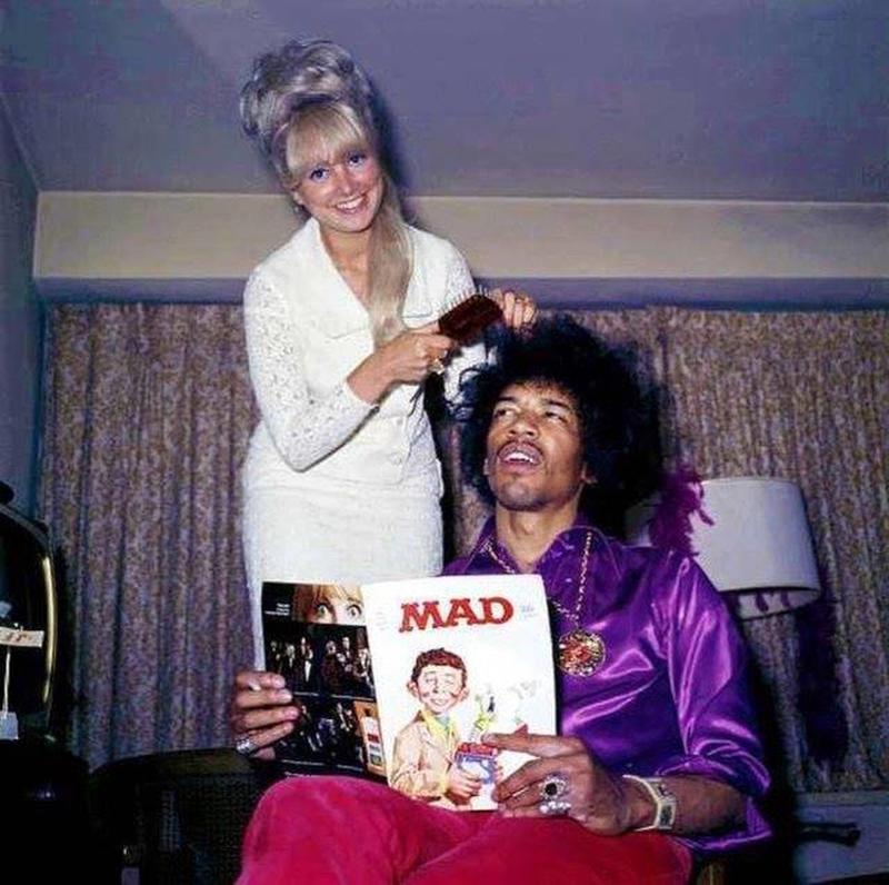 Jimi Hendrix indulges in Mad Magazine while having his hair styled in 1968